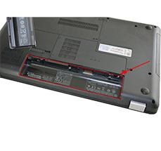 Printed on the label inside the battery compartment of the laptop